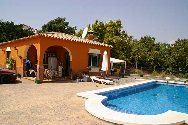 Photo of a small beach house with a swimming pool