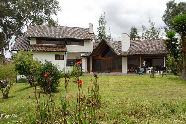 Photo example of a modern country home with a big garden