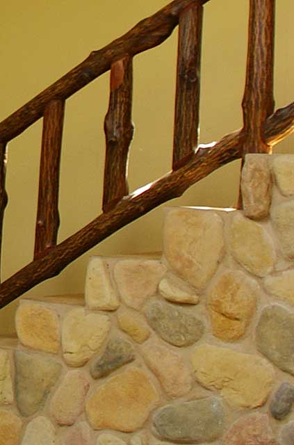Example decor idea on a traditional old country home with a stairway decorated wall with natural stones