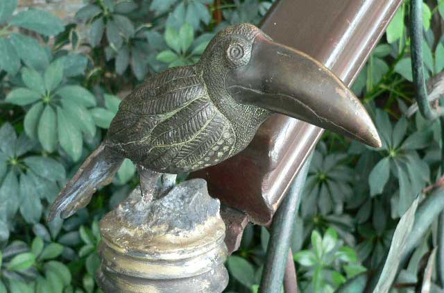  A little iron toucan decorates this stairway railing