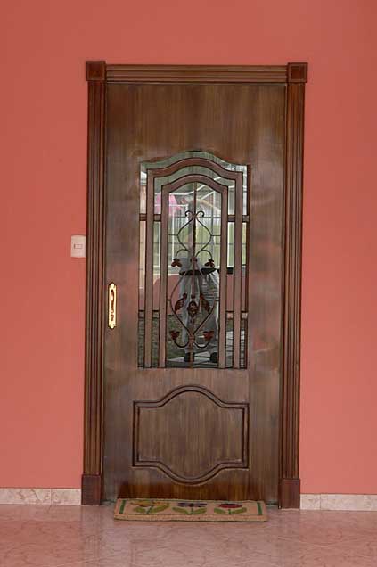 Photo example of a decorative metal door painted in brown color with wood imitation effects