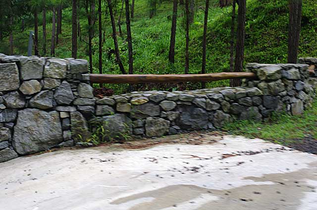 Photo Example of a simple stone wall around a mountain property with a wood bar
