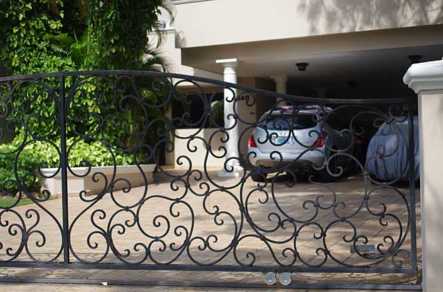 Photo example of a black metal gate in front of a city home