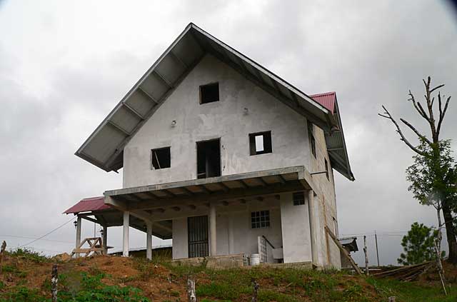 Example photo of a small 3 story mountain country house under construction