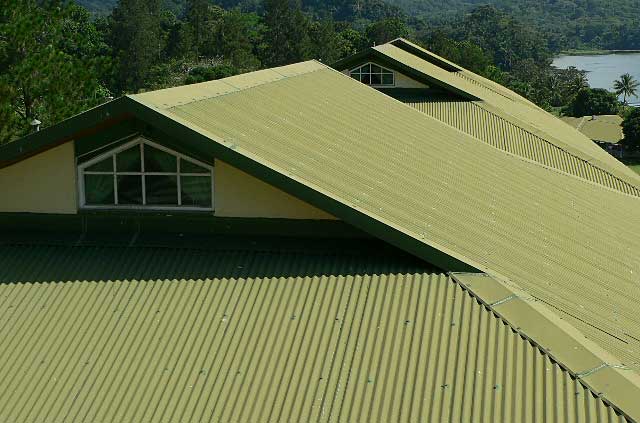 Example photo of a tropical resort hotel covered with green with zinc roofing material.
