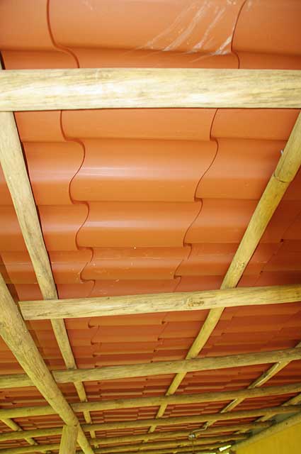 Example picture of the underside of a terrace roof on a country house with rustic tree beams